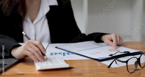 Businesswoman or Accountant working with calculator for investigation of corruption account.