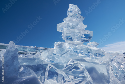 Ice floe crystal under blue sky background.