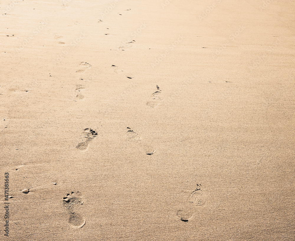 Footprint background. Barefoot walking on the smooth sandy beach. Footprint background. Barefoot walking on the smooth sandy beach.