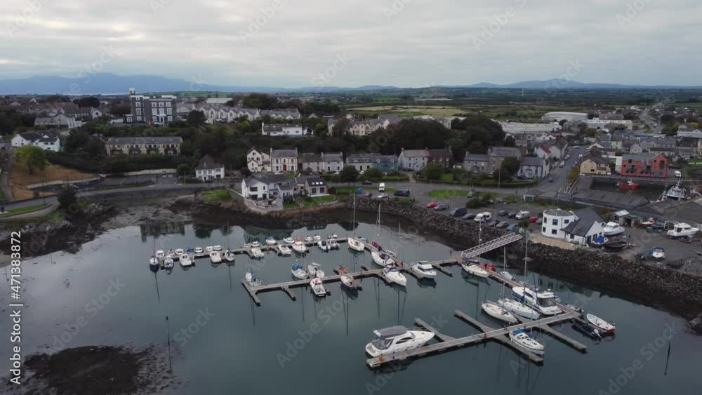 Aerial view of Ardglass marina and town on a cloudy day, County Down, Northern Ireland. Moving away from town with marina below. Aerial view of Ardglass marina and town on a cloudy day, County Down, Northern Ireland. Moving away from town with marina below.