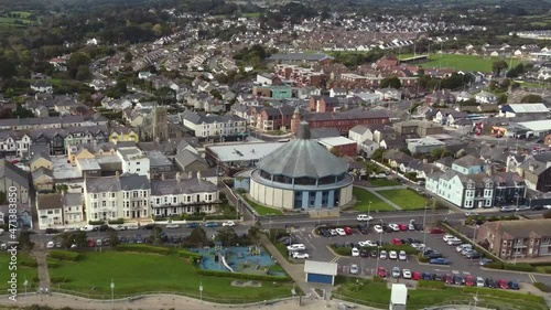 Aerial view of the town of Newcastle on a sunny day, County Down, Northern Ireland. Flying over the beach tracking the town left to right with zoom out. photo