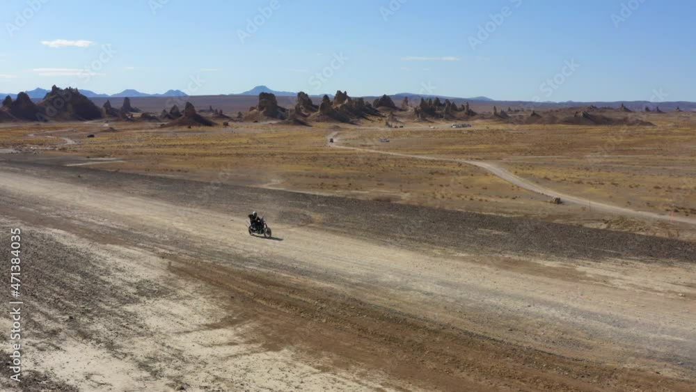 Drone shot of biker crossing Pinnacles desert during a hot sunny day, United States Drone shot of biker crossing Pinnacles desert during a hot sunny day, United States