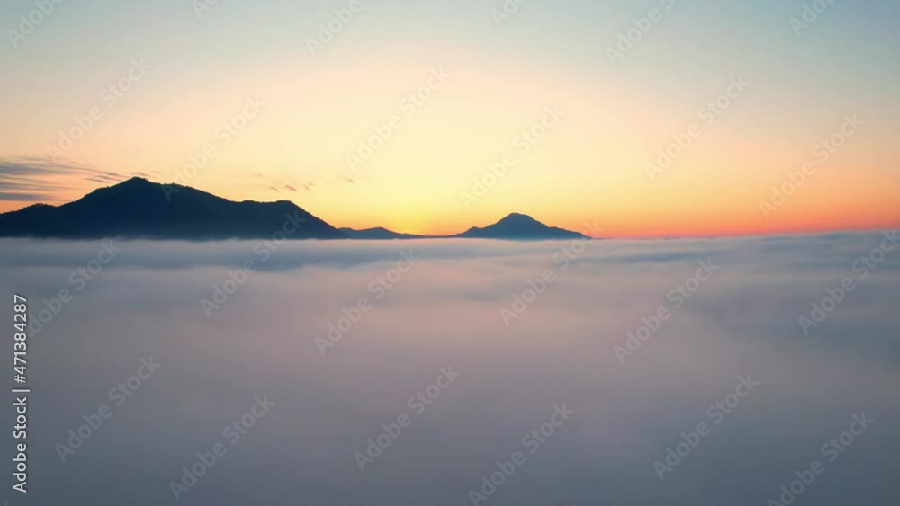4K Aerial video Beautiful sunrise above dense clouds and fog in the morning, Cinematic drone shot.
4K Aerial video Beautiful sunrise above dense clouds and fog in the morning, Cinematic drone shot.
