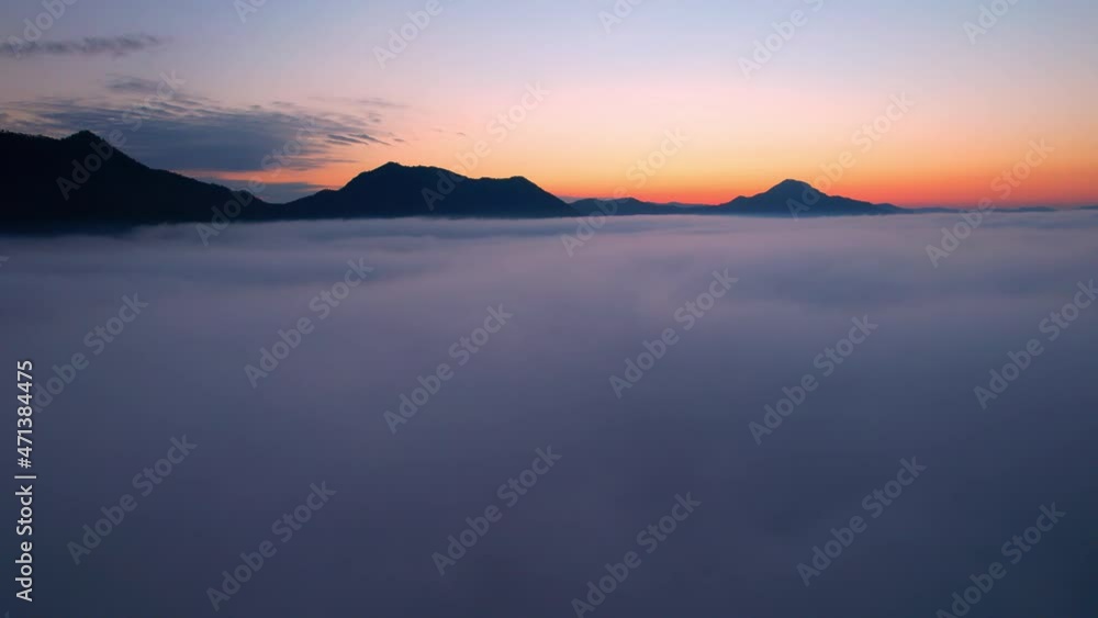 4K Flying through the clouds above mountain tops. Tropical forest with smoke and fog.
4K Flying through the clouds above mountain tops. Tropical forest with smoke and fog.