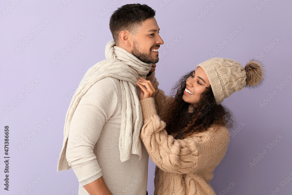 Happy couple in winter clothes on color background Happy couple in winter clothes on color background