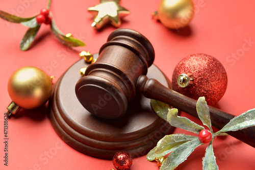 Judge's gavel and Christmas decor on color background photo