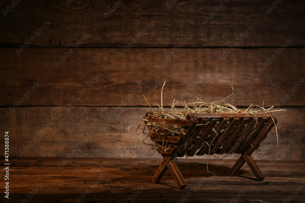 Manger with hay on wooden background Stock Photo | Adobe Stock