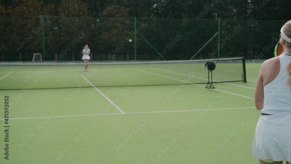 Back view of female tennis player hits the ball with a racket, female ...