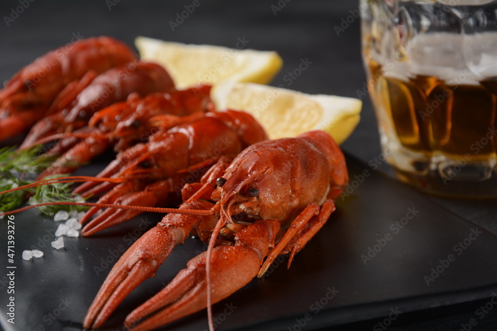 Red boiled crawfishes on table in rustic style. Asian Chinese Food Spicy Crayfish with a mug of beer. Red boiled crawfishes on table in rustic style. Asian Chinese Food Spicy Crayfish with a mug of beer.