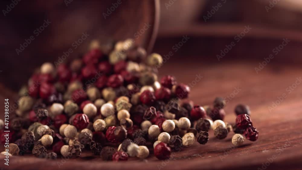 Colorful Pepper falling on a wooden table .Slow motion. Close up Colorful Pepper falling on a wooden table .Slow motion. Close up