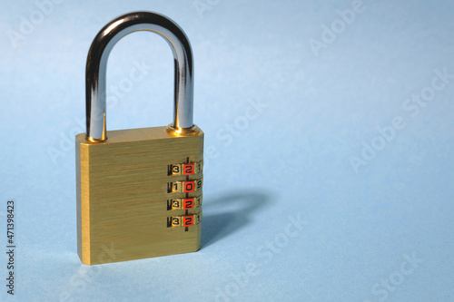 Concept. New Year. Brass yellow combination closed lock on a light blue background. On disks figures 2022. Lockdown, restrictions, covid.