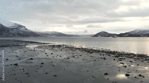 Scenic View From The Coast Of Balsfjorden, A Fjord In Troms og Finnmark, Norway With Overcast. low-level, slider shot photo