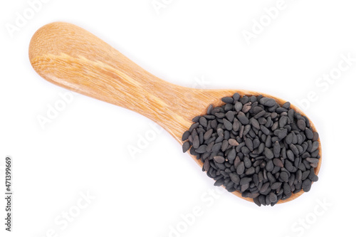 Black sesame seeds organic in wooden spoon on white background. Health food concept.