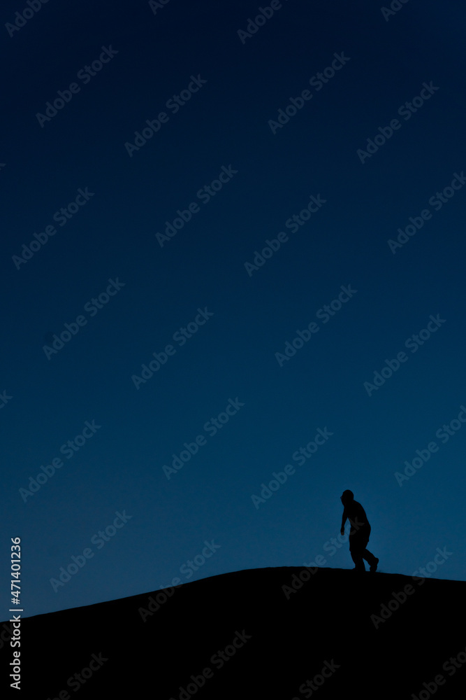 Silhouette of a man climbing the peak forever