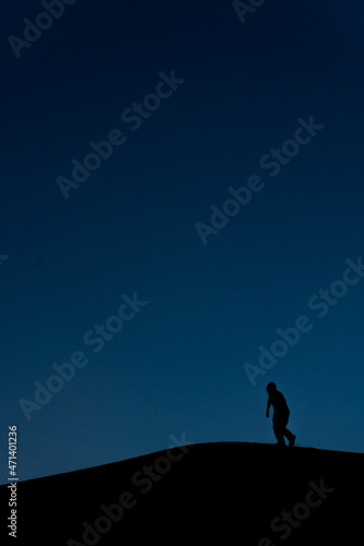 Silhouette of a man climbing the peak forever