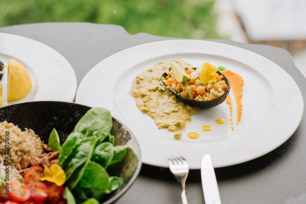Dish with avocado and chopped wegetables with sauce. Detox menu Dish with avocado and chopped wegetables with sauce. Detox menu