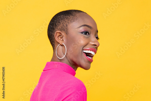 Fotografia, Obraz Happy smiling beautiful African American woman looking away in isolated on yello