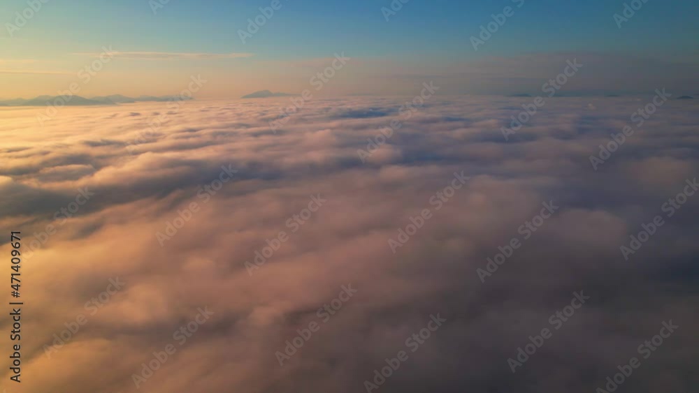 4K Aerial video Beautiful sunrise above dense clouds and fog in the morning, Cinematic drone shot.
4K Aerial video Beautiful sunrise above dense clouds and fog in the morning, Cinematic drone shot.