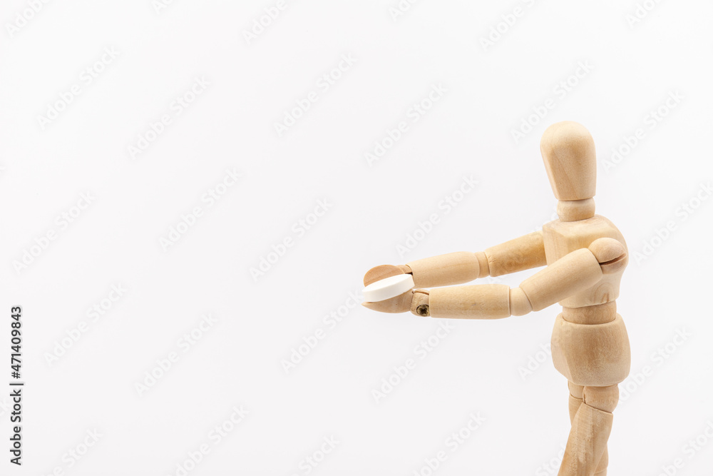 Wooden mannequin with pills on white background. Concept of pharmaceuticals and supplements. Wooden mannequin with pills on white background. Concept of pharmaceuticals and supplements.