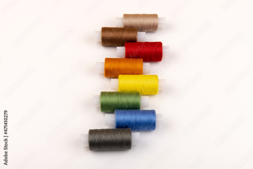 Color sewing threads isolated on white background. Different colors.Bright bobbin thread. Color sewing threads isolated on white background. Different colors.Bright bobbin thread.