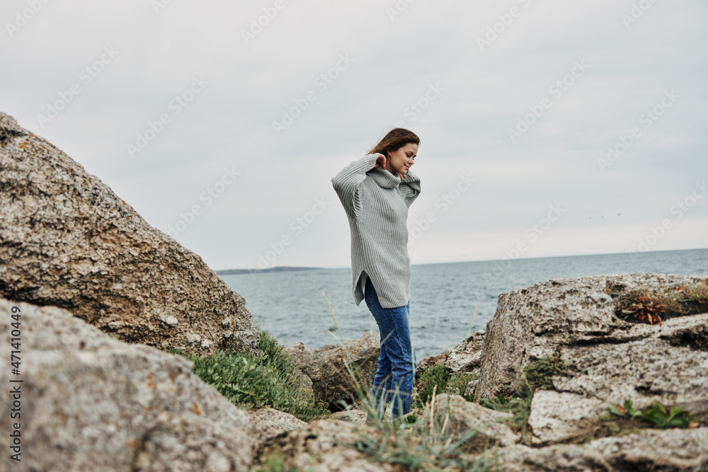 portrait of a woman beach tourism cloudy weather stone coast Relaxation concept