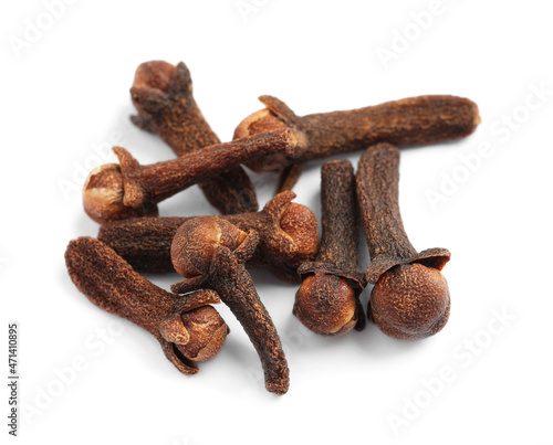 Pile of aromatic dry cloves on white background