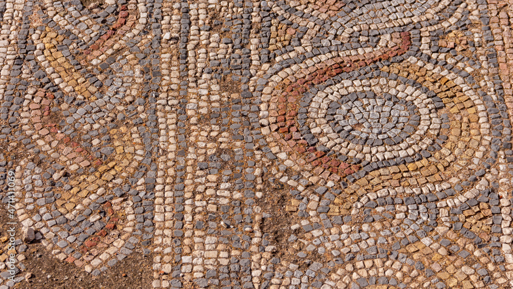 Closeup view of mosaics fragment in Hadrian's Library, Athens, Greece. Beautiful patterned ornament floor in old ruins background. Archeology and history concept Closeup view of mosaics fragment in Hadrian's Library, Athens, Greece. Beautiful patterned ornament floor in old ruins background. Archeology and history concept