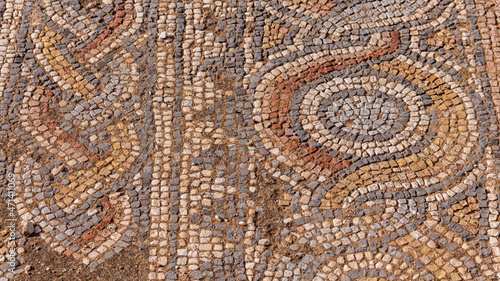Closeup view of mosaics fragment in Hadrian's Library, Athens, Greece. Beautiful patterned ornament floor in old ruins background. Archeology and history concept