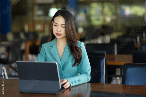 Businesswoman focused on her project on a digital tablet computer