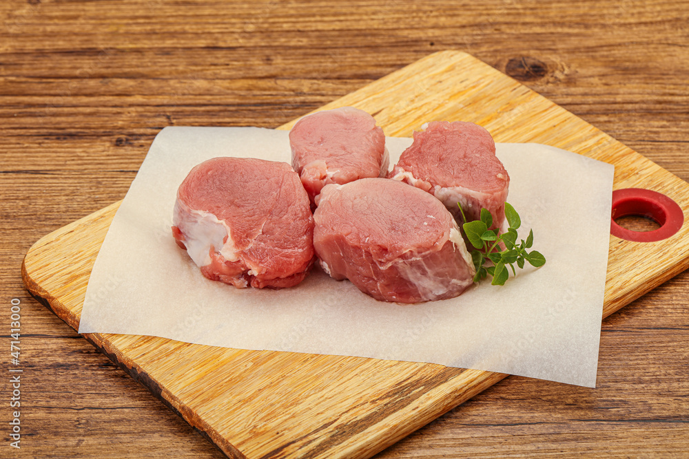 Raw pork medallion served rosemary Raw pork medallion served rosemary