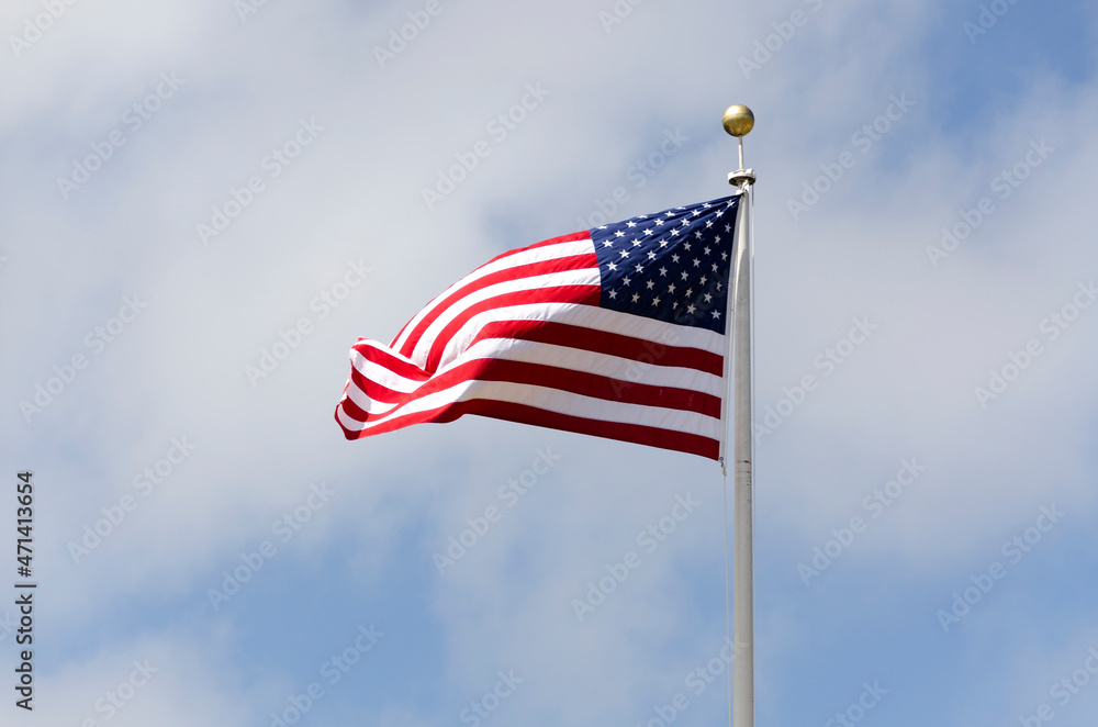 Naklejka premium stars and stripes flag waving at the wind in United states of America