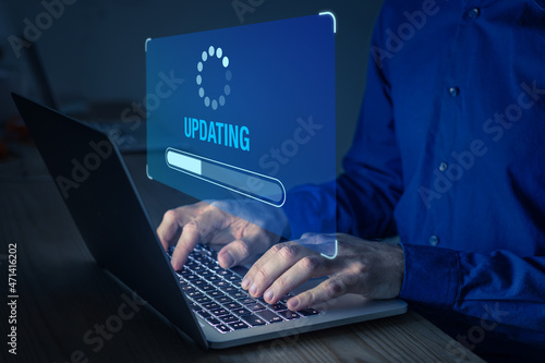 Software update or operating system upgrade to keep the device up to date with added functionality in new version and improve security. Updating progress bar on computer screen. Installing app patch.
