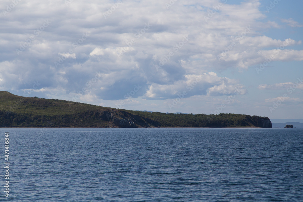 day view of the sea, islets, capes, white clouds and blue sky in the Novik harbor on island Russky in Vladivostok, Russia day view of the sea, islets, capes, white clouds and blue sky in the Novik harbor on island Russky in Vladivostok, Russia