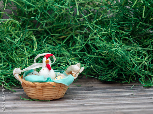 Easter eggs and chicken in a basket. Easter card with copy space for text.