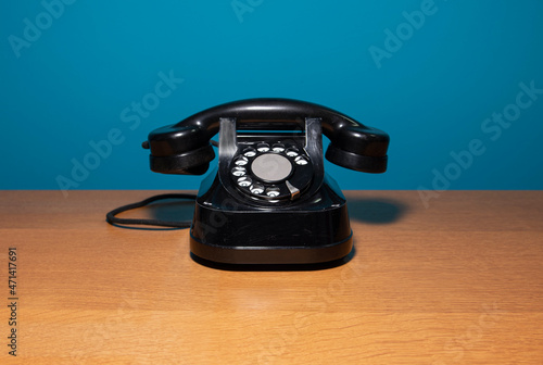 old black telephone on a light background