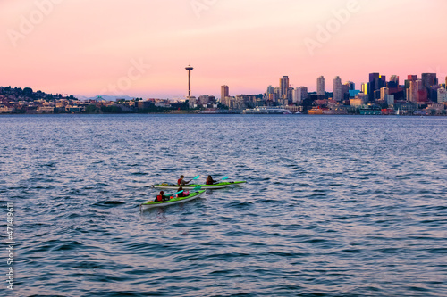 Kayaking in the Puget Sound with Seattle skyline at sunset
