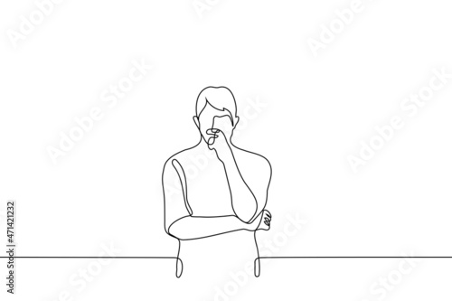 man stands tensely thinking he crossed his arms with one hand to his face - one line drawing vector. concept of brainstorming, intelligent person ponders, make a decision, reflection