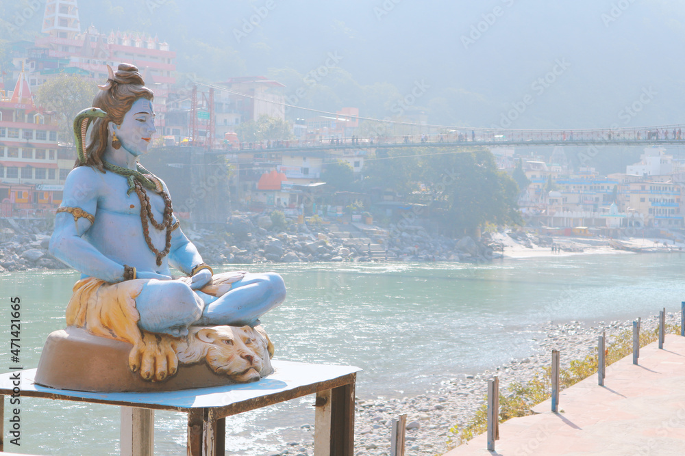 Pilgrimage Rishikesh A sculpture of Lord Shiva in front of the Lakshman Jula Bridge in ...