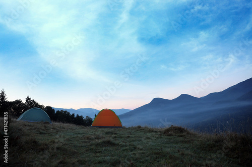 Camping tents on mountain slope in morning