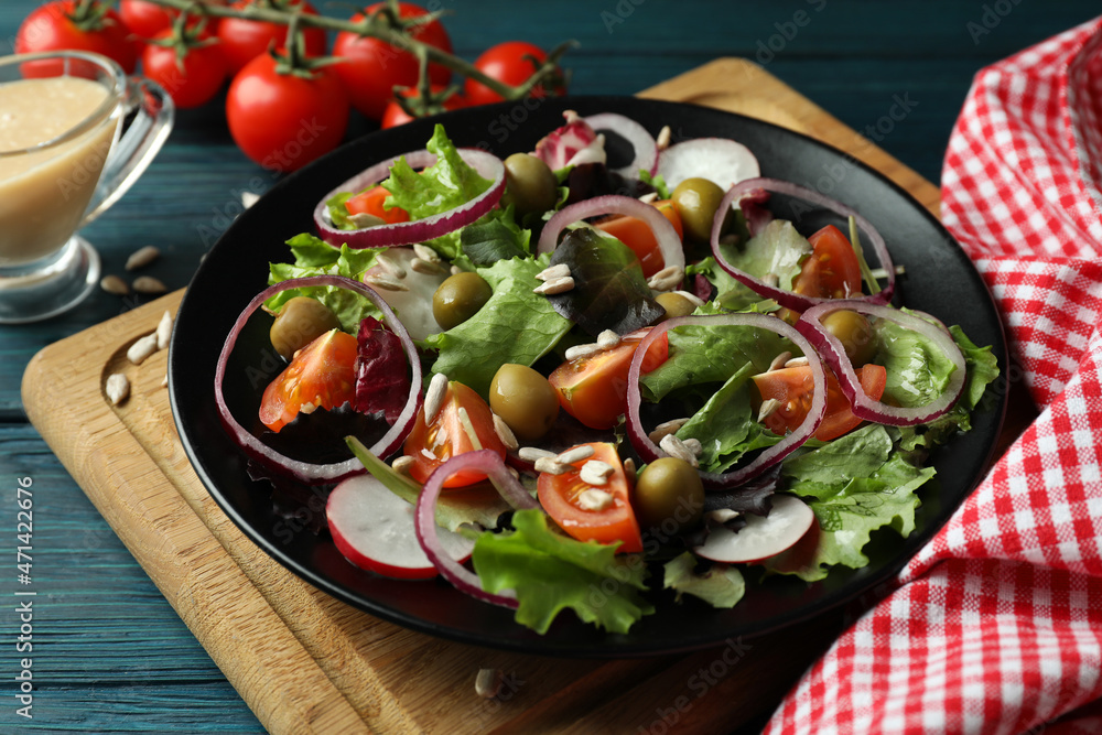 Concept of tasty food with vegetable salad with tahini sauce on wooden background Concept of tasty food with vegetable salad with tahini sauce on wooden background