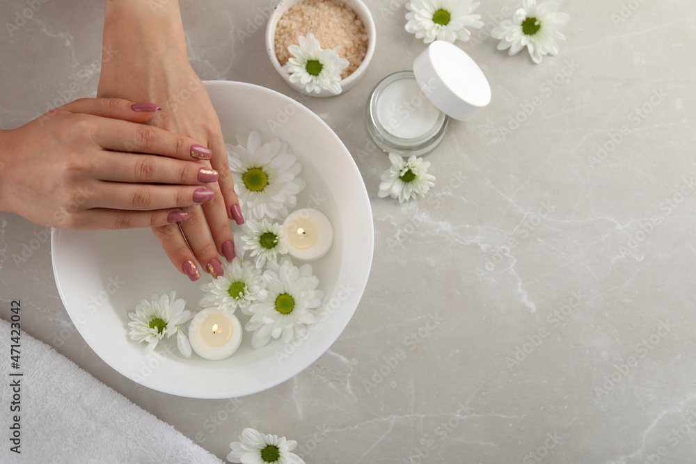 Concept of hand care with cosmetics on gray textured background Concept of hand care with cosmetics on gray textured background