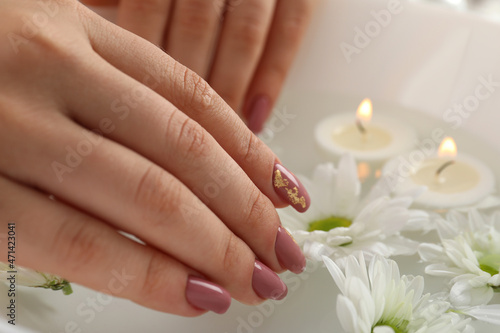 Concept of hand care with cosmetics on gray textured background