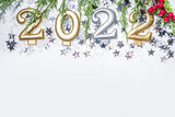 2022 new year greeting card background, festive banner with 2022 holiday candles, silver star decor, christmas tree branches and artificial snow