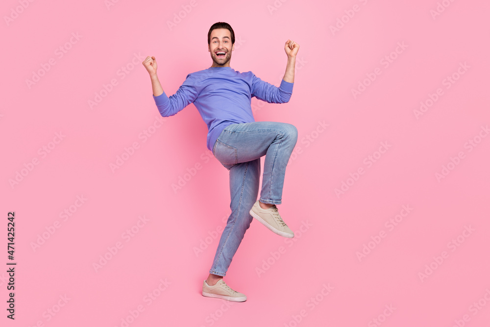 Full size photo of brunet cool guy yell wear pullover jeans shoes isolated on pink color background Full size photo of brunet cool guy yell wear pullover jeans shoes isolated on pink color background