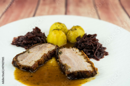 Schweinebraten Pork Royal mit Rotkohl und Salzkartoffeln photo