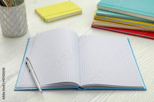 Foto Open notebook and pen on white wooden table. Personal planning