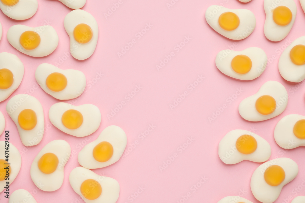 Tasty jelly candies in shape of egg on pink background, flat lay. Space for text Tasty jelly candies in shape of egg on pink background, flat lay. Space for text