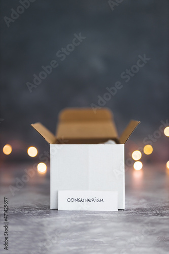 consumerism concept, delivery parcels for goods purchased with shiny fairy lighrts in the background and label with text photo