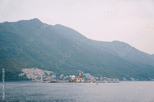 Church of Our Lady on the rocks against the background of Perast. Montenegro © Nadtochiy