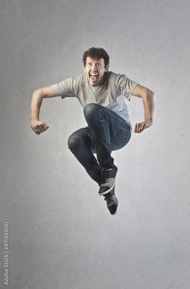 young white man jumps cheerful